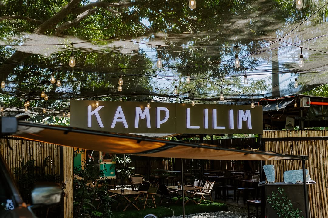 Kamp Lilim entrance sign in daytime with bamboo and trees