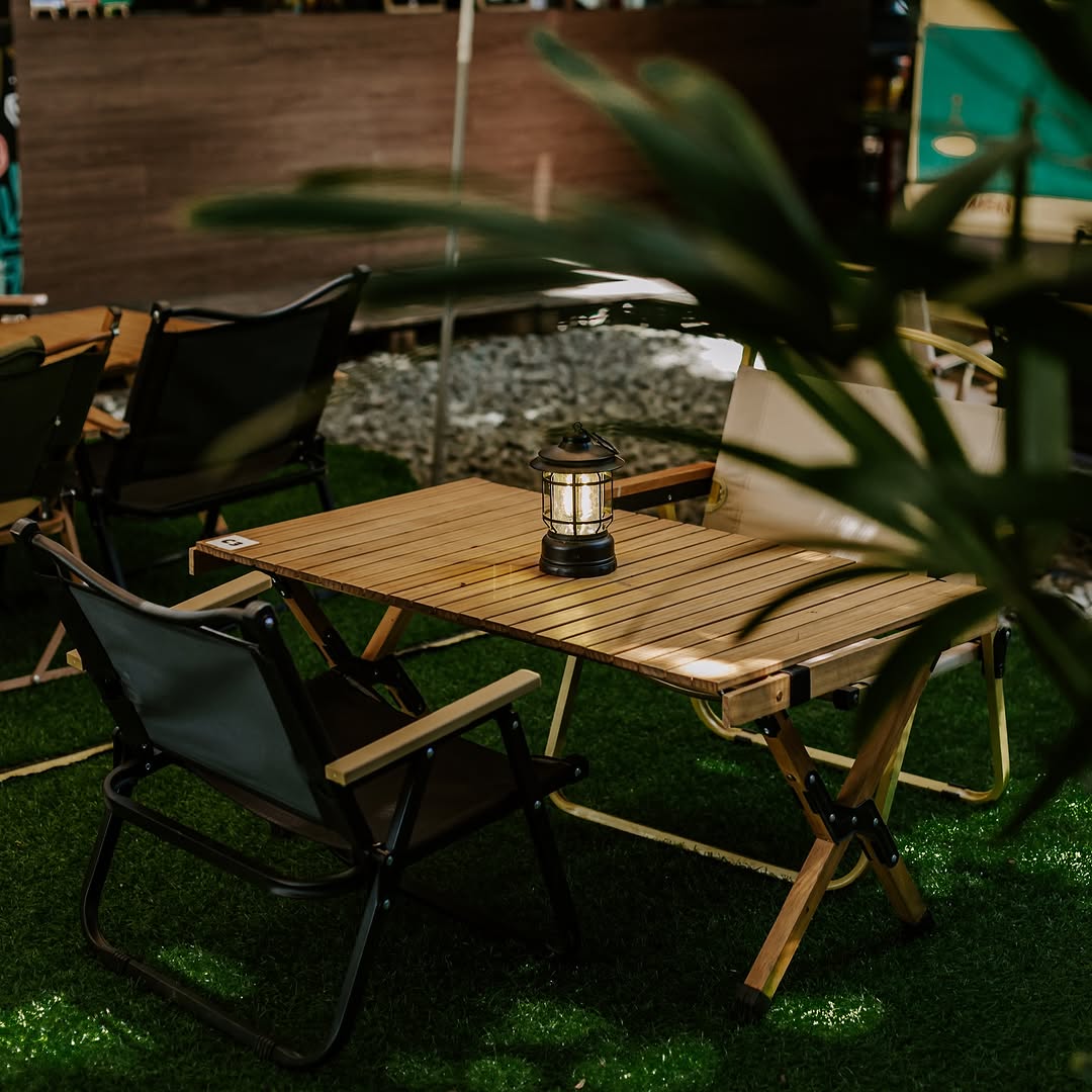 Kamp Lilim outdoor campsite seating with lantern at dusk